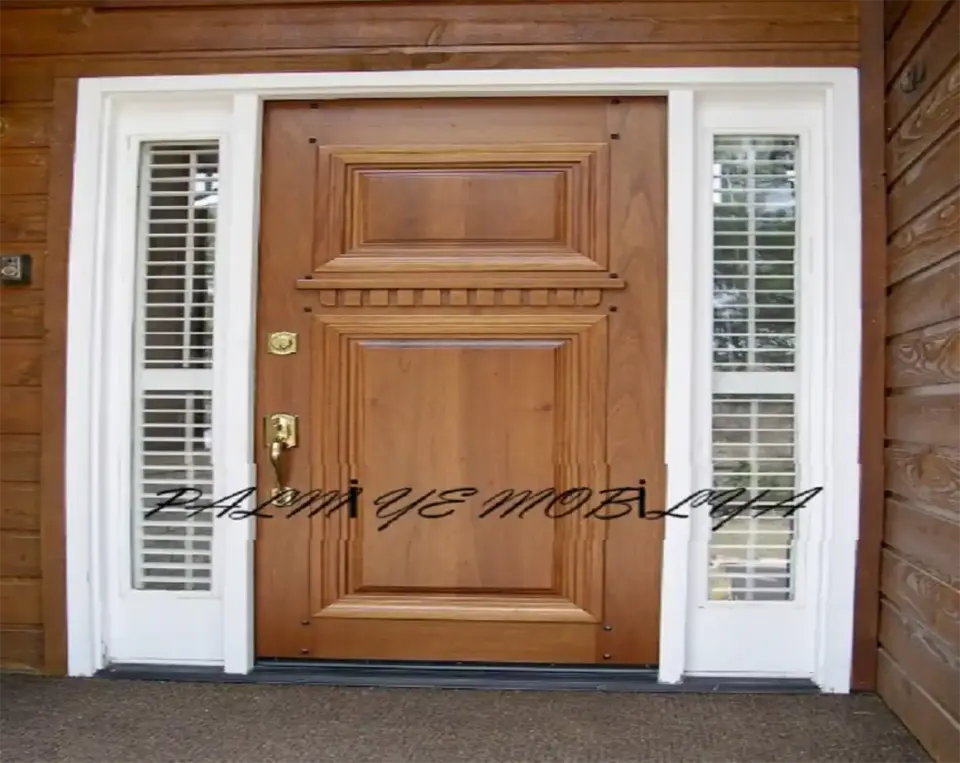 Wooden front door with brass handle flanked by white shuttered sidelights