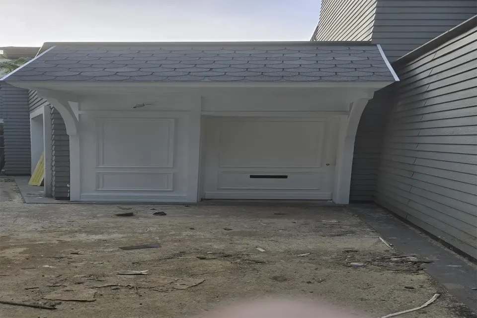 Scalloped shingle canopy over a white panelled double door with letter slot