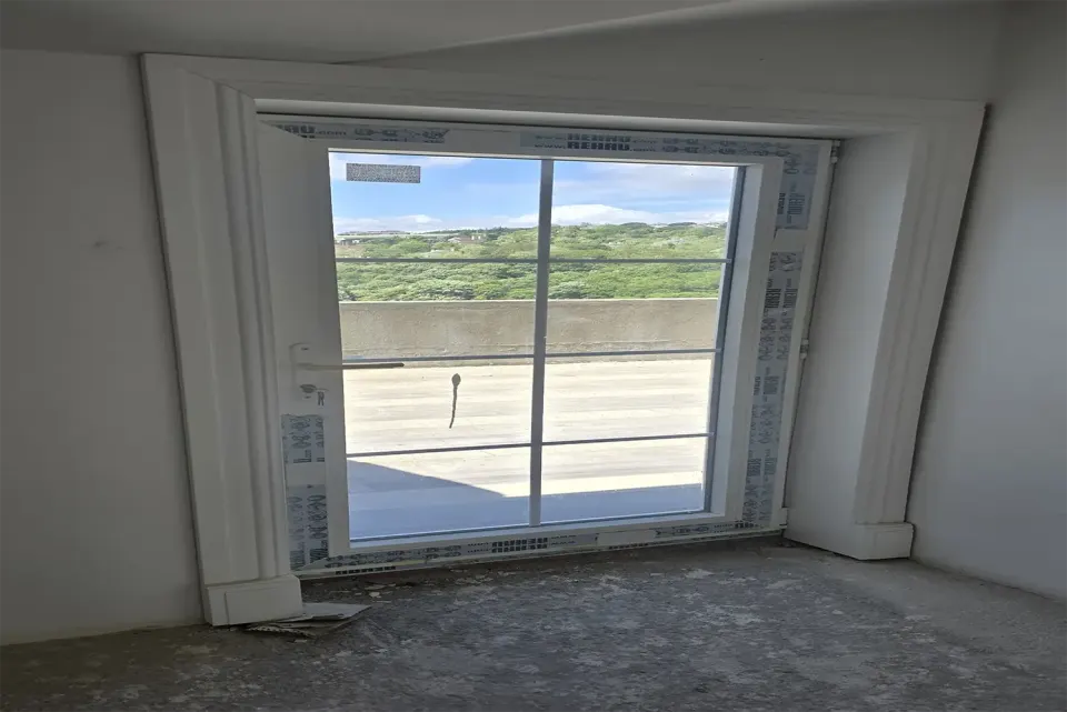 White moulded timber casing framing a balcony door during the refit