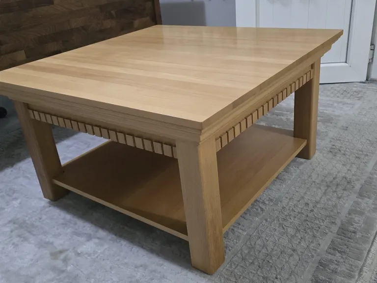 Square coffee table with dentil apron, light oak tone